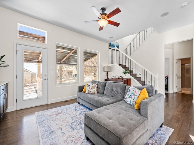 living room with ceiling fan and dark hardwood / wood-style flooring