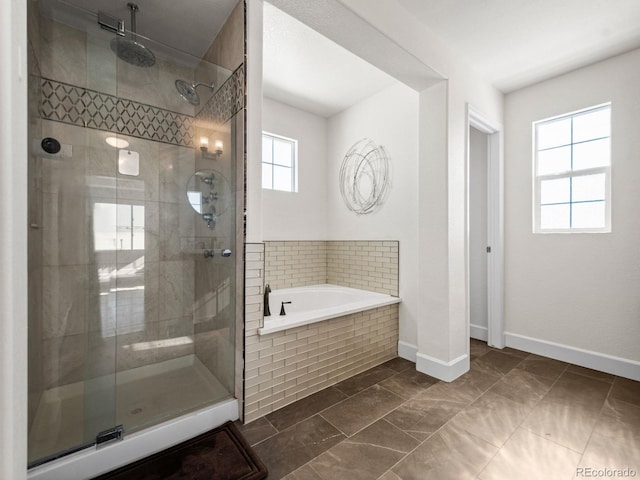 bathroom featuring separate shower and tub and a wealth of natural light