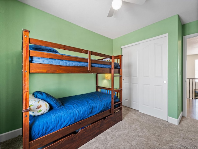 carpeted bedroom featuring a closet and ceiling fan