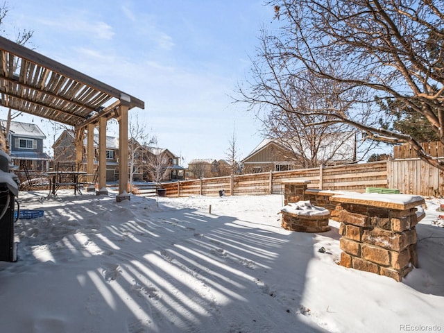 snow covered patio featuring a fire pit and a pergola