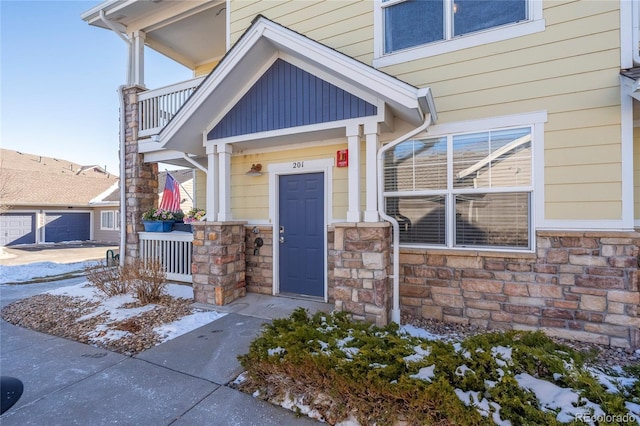 entrance to property featuring a balcony and a garage