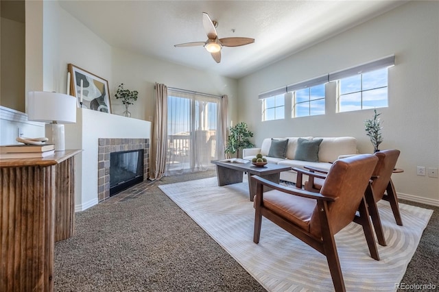 carpeted living room featuring ceiling fan and a tile fireplace