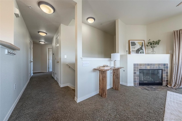 hall with dark colored carpet