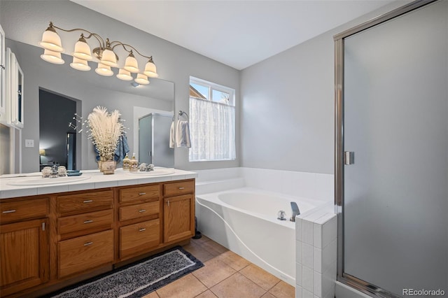 bathroom featuring a bath, tile patterned flooring, a sink, and a shower stall