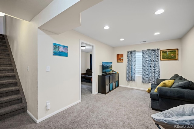 carpeted living room with recessed lighting, baseboards, and stairs