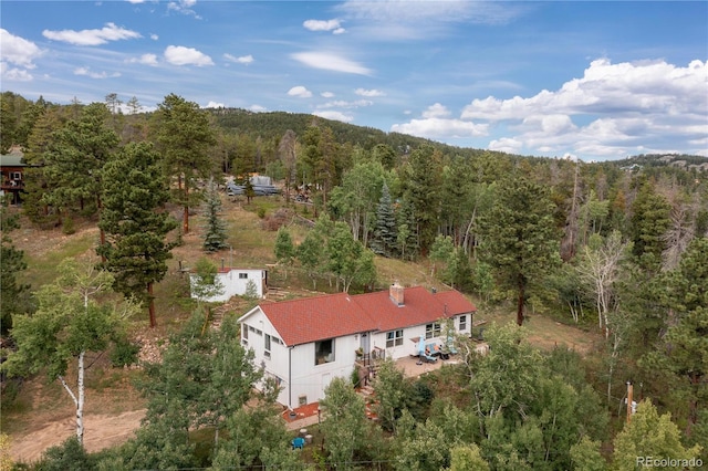 drone / aerial view with a wooded view