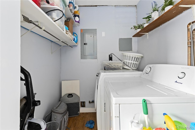 washroom with electric panel, hardwood / wood-style flooring, and independent washer and dryer