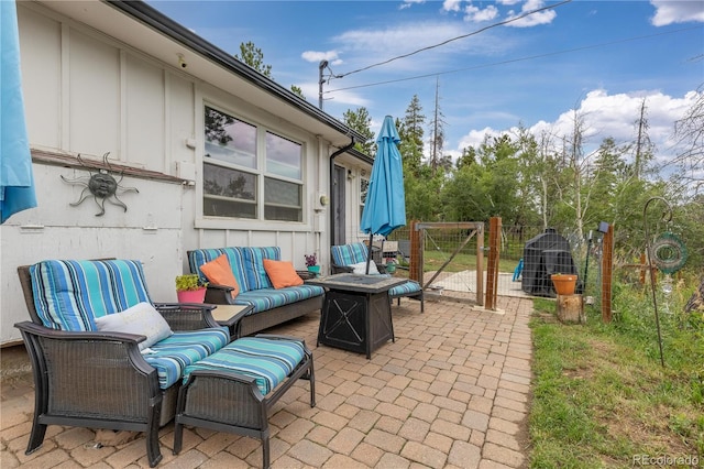 view of patio / terrace with an outdoor living space with a fire pit