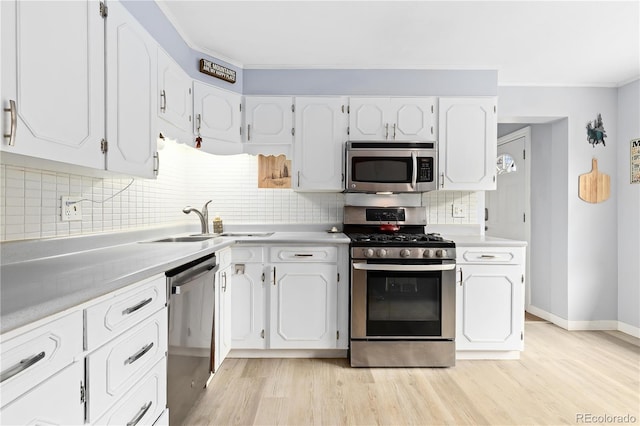 kitchen with white cabinetry, appliances with stainless steel finishes, and light countertops