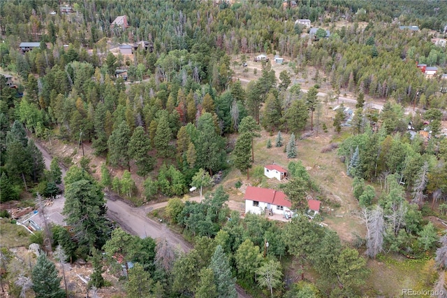 drone / aerial view featuring a forest view