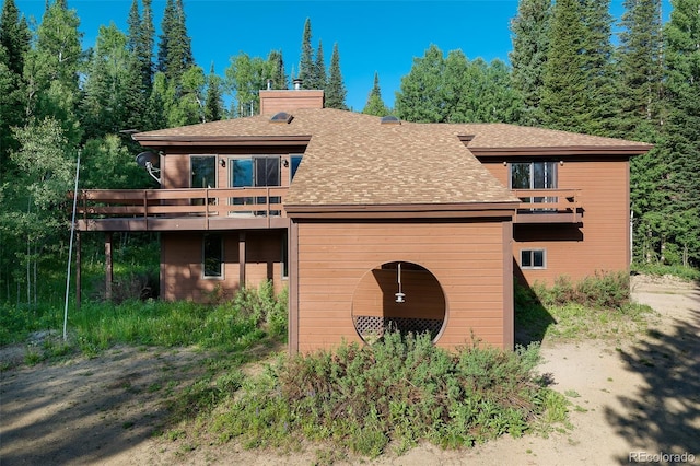 2246 Gcr 8, Fraser, CO 80442 - view of property exterior with a chimney, roof with shingles, and a deck