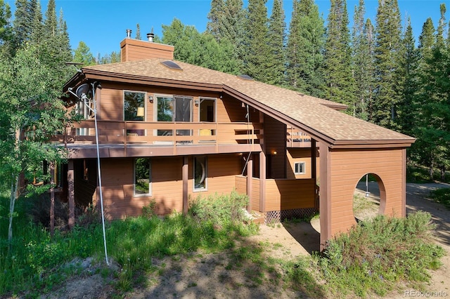 2246 Gcr 8, Fraser, CO 80442 - view of front of property featuring roof with shingles, a chimney, and a wooden deck