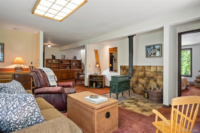 2246 Gcr 8, Fraser, CO 80442 - carpeted living room featuring a wood stove and baseboard heating