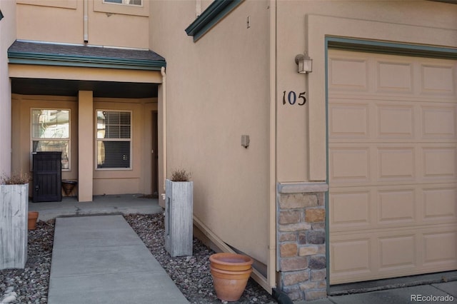 view of exterior entry featuring a garage