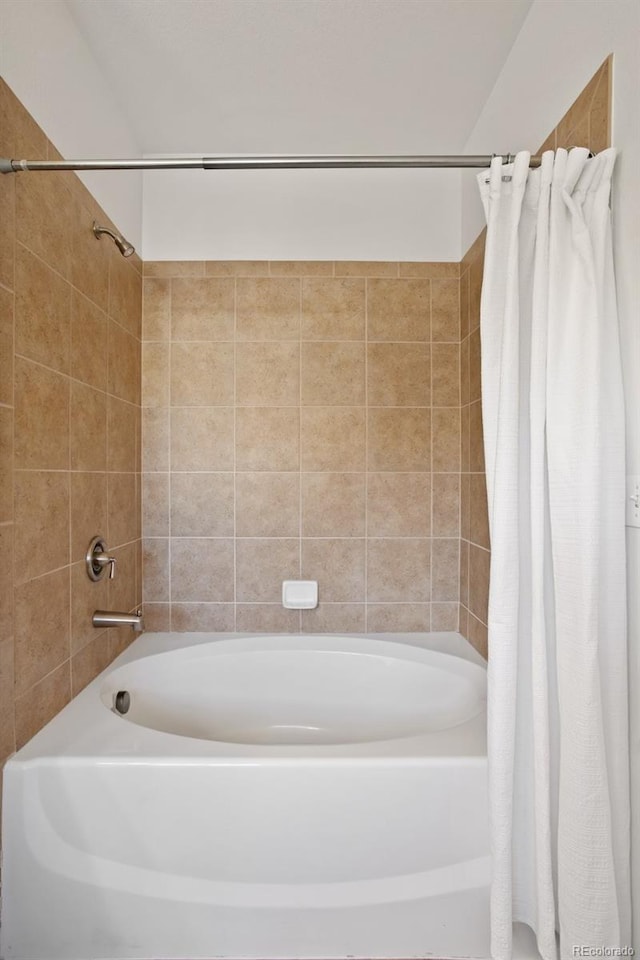 bathroom with shower / tub combo with curtain