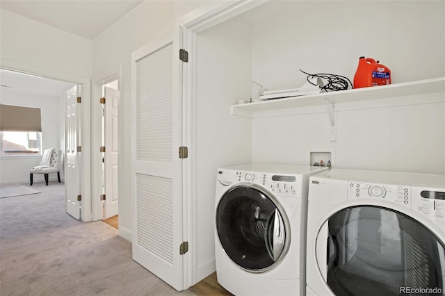 washroom with separate washer and dryer and light carpet