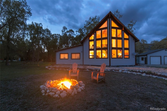 426 S San Juan Ave, Buena Vista, CO 81211 - rear view of property featuring an outdoor fire pit, an outbuilding, and a detached garage