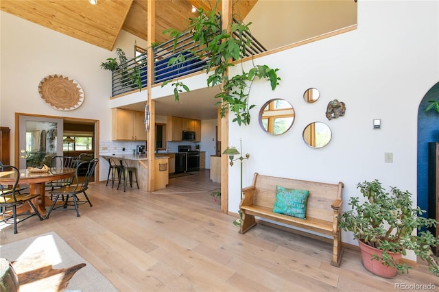 426 S San Juan Ave, Buena Vista, CO 81211 - living room featuring high vaulted ceiling, light wood-style floors, arched walkways, and wood ceiling