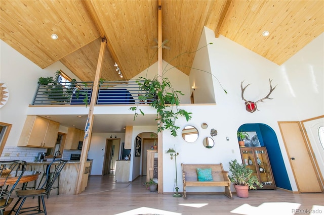 426 S San Juan Ave, Buena Vista, CO 81211 - living room with arched walkways, high vaulted ceiling, wood ceiling with exposed beams, light wood-type flooring, and recessed lighting
