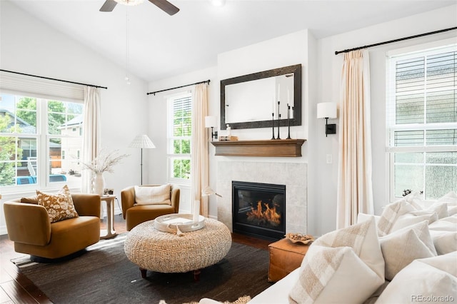 3320 Yukon Ct, Wheat Ridge, CO 80033 - living area with wood finished floors, a tiled fireplace, healthy amount of natural light, vaulted ceiling, and a ceiling fan