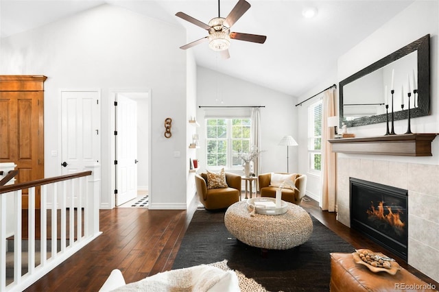 3320 Yukon Ct, Wheat Ridge, CO 80033 - living room featuring a tile fireplace, wood-type flooring, a ceiling fan, high vaulted ceiling, and baseboards