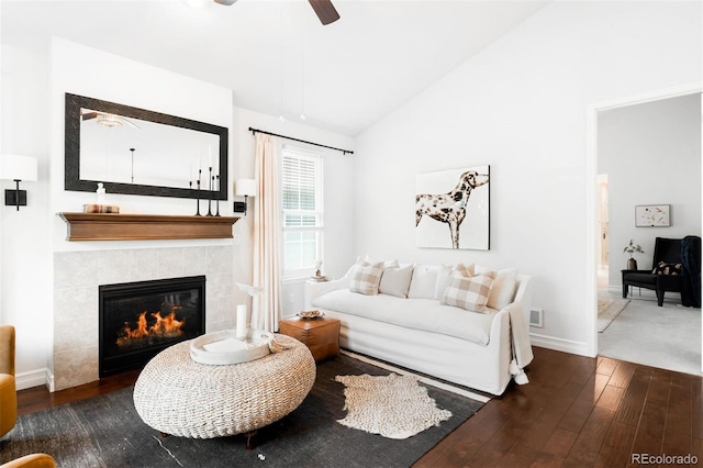 3320 Yukon Ct, Wheat Ridge, CO 80033 - living room with a ceiling fan, a tile fireplace, wood-type flooring, vaulted ceiling, and baseboards