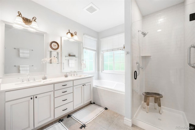 3320 Yukon Ct, Wheat Ridge, CO 80033 - bathroom featuring a shower stall, double vanity, a bath, and tile patterned floors