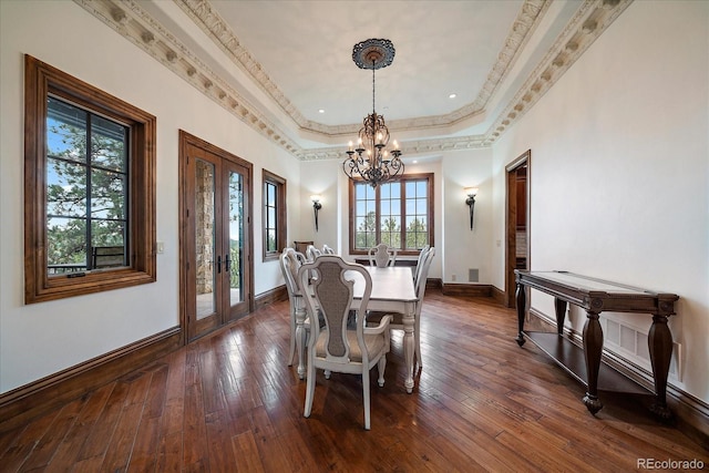 dining area featuring dark wood-style floors, french doors, crown molding, a raised ceiling, and baseboards