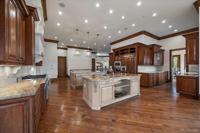 kitchen with built in appliances, open shelves, a spacious island, and pendant lighting