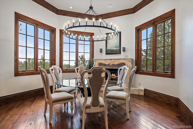 dining space with wood-type flooring, baseboards, and ornamental molding