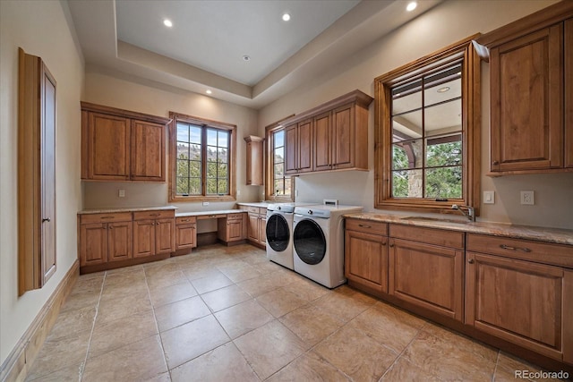 laundry area with recessed lighting, cabinet space, a sink, and washer and clothes dryer