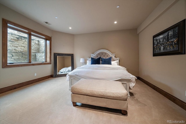 bedroom featuring light colored carpet, visible vents, and baseboards