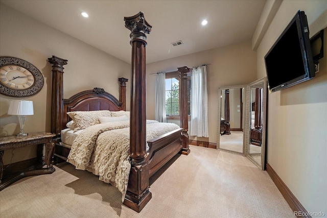 bedroom featuring recessed lighting, light colored carpet, visible vents, baseboards, and ornate columns