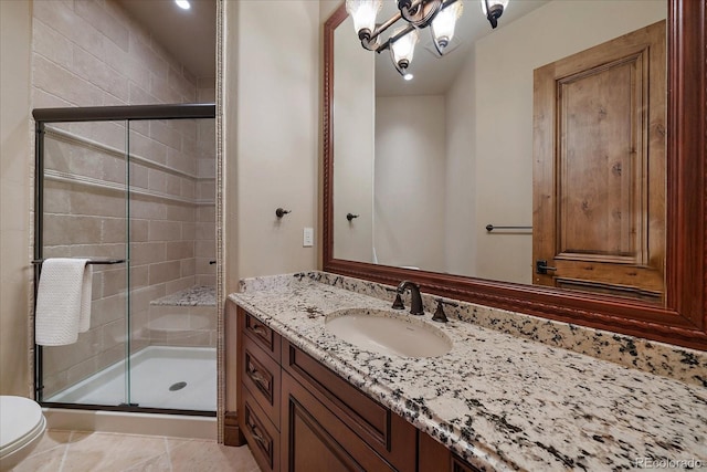 full bathroom with vanity, a shower stall, toilet, and tile patterned floors