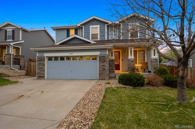 13818 Krameria St, Thornton, CO 80602 - view of front facade featuring driveway, fence, covered porch, stone siding, and a front lawn