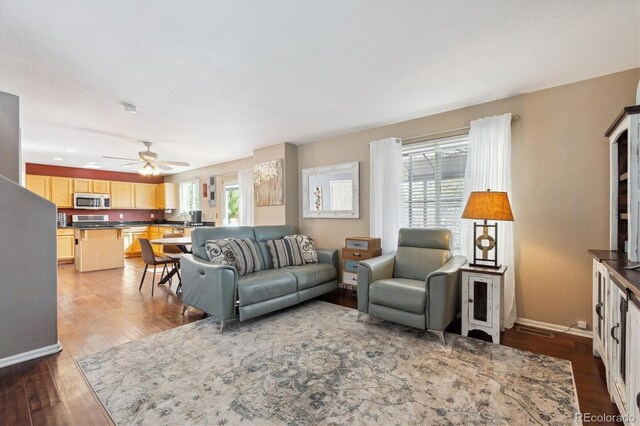 13818 Krameria St, Thornton, CO 80602 - living area featuring baseboards, visible vents, ceiling fan, and wood finished floors
