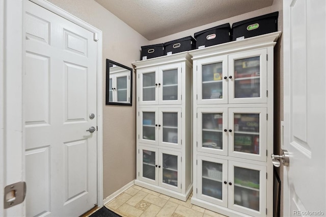13818 Krameria St, Thornton, CO 80602 - doorway to outside with a textured ceiling and baseboards
