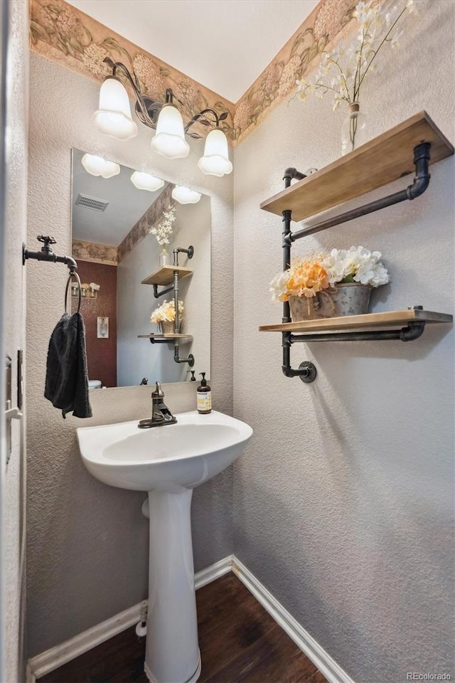 13818 Krameria St, Thornton, CO 80602 - bathroom with baseboards, visible vents, and wood finished floors