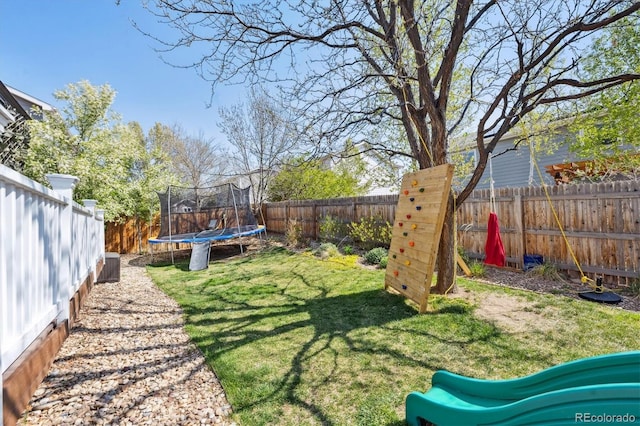 13818 Krameria St, Thornton, CO 80602 - view of yard featuring a trampoline and a fenced backyard