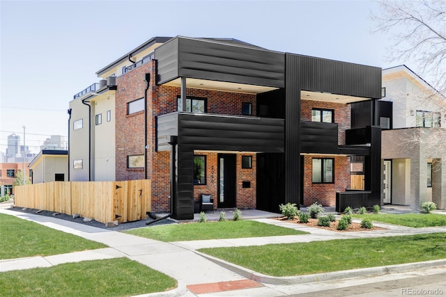view of front of home with brick siding and fence