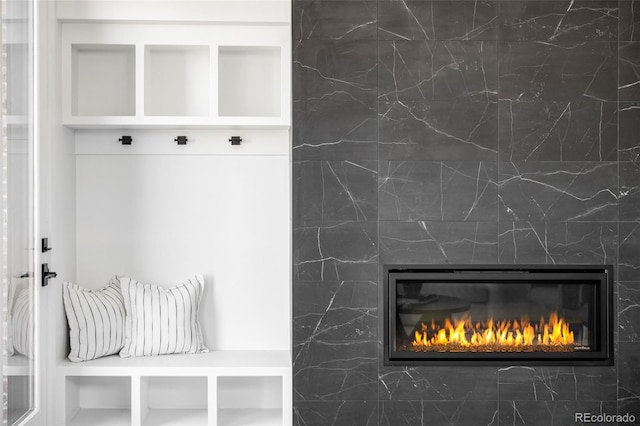 mudroom with a glass covered fireplace