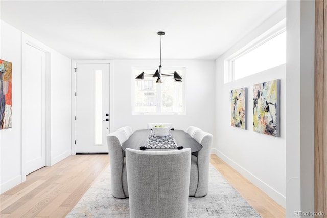 dining space with light wood-style floors and baseboards
