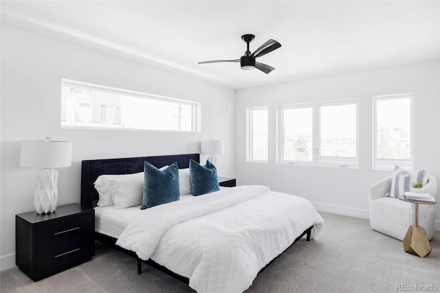 bedroom with light carpet, baseboards, and ceiling fan