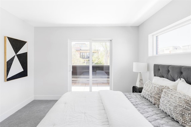carpeted bedroom featuring baseboards