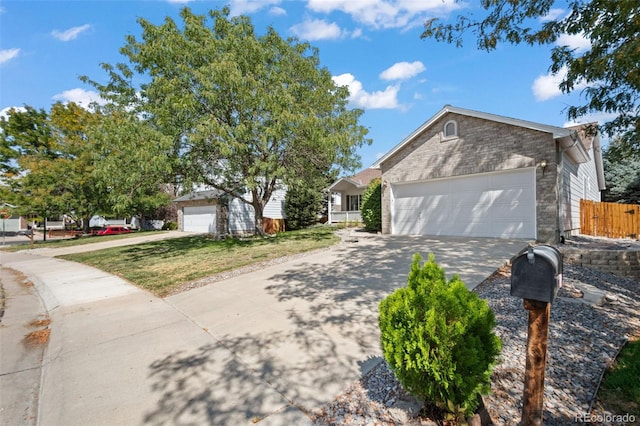 view of front of home with a garage and a front lawn