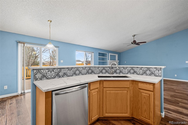 kitchen featuring hanging light fixtures, a kitchen island with sink, dishwasher, and sink