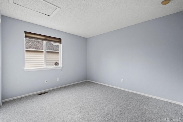 carpeted spare room with a textured ceiling