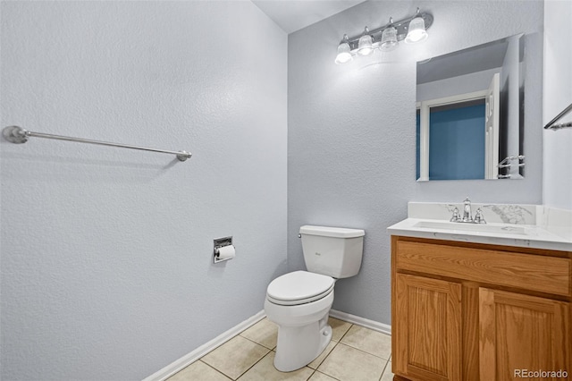 bathroom featuring toilet, vanity, and tile patterned flooring