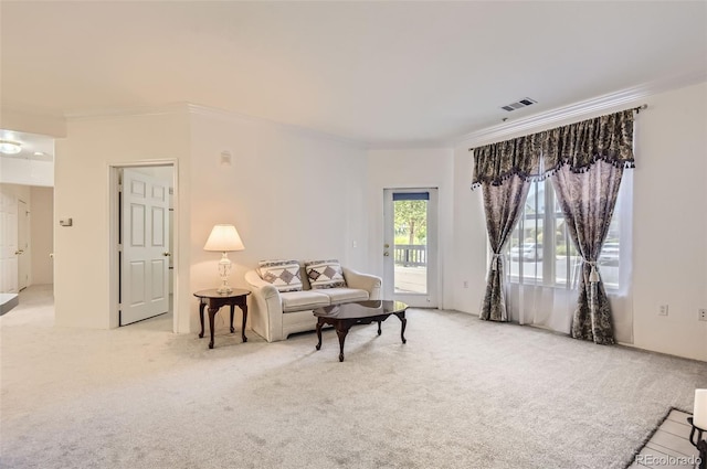 living room with light colored carpet and ornamental molding