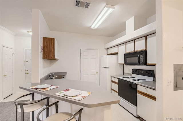 kitchen featuring crown molding, white appliances, kitchen peninsula, sink, and white cabinets